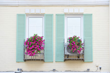 Windows With Wooden Shutters Decorated With Pink Flowers