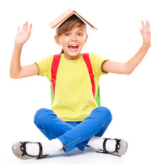 Fototapete - Portrait of a cute little schoolgirl with backpack