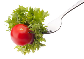 Fresh salad and cherry tomato on fork isolated on white backgrou