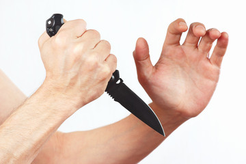 Hand position for defense with a army knife on white background