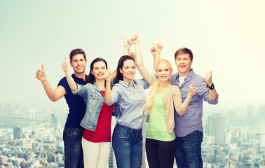 Wall Mural - group of smiling students showing thumbs up