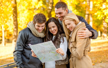 Poster - group of friends with map outdoors