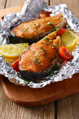 Poster - Tasty baked fish in foil on table close-up