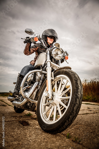 Fototapeta na wymiar Biker girl on a motorcycle