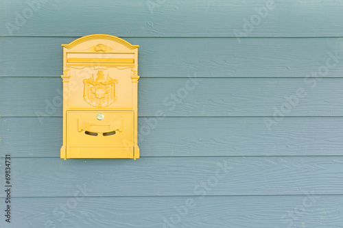 Cuadros en Lienzo Yellow mailbox with green wood background