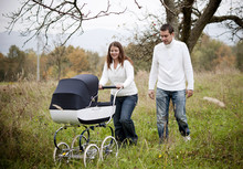 Family With Vintage Pram Relaxing In Nature