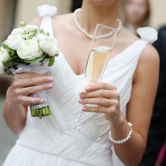 Wall Mural - Bride holding a glass of champagne