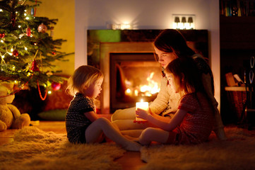 Happy family by a fireplace on Christmas