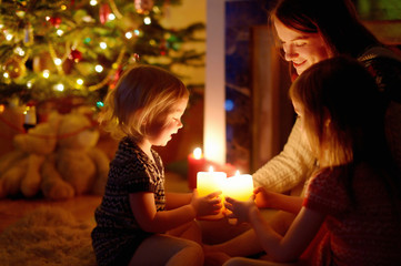 Happy family by a fireplace on Christmas