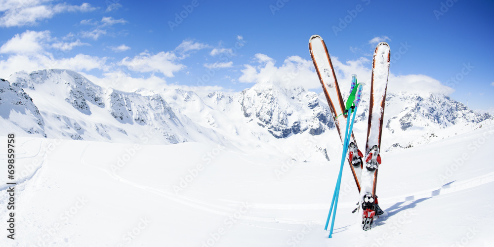 Skiing , mountains and ski equipments on ski run - obrazy, fototapety, plakaty 