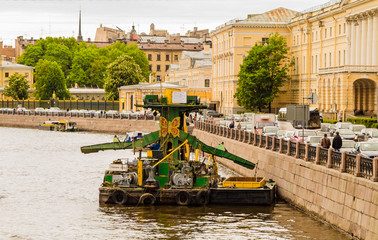 moored to a quay, old dredging platform in the river