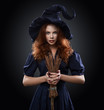 beautiful red-haired girl in a  costume witch