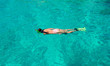 © travnikovstudio - Beautiful girl snorkeling in clear tropical turquoise waters