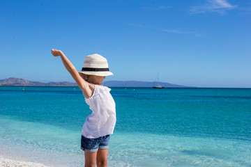 Adorable little girl have fun at tropical beach during vacation