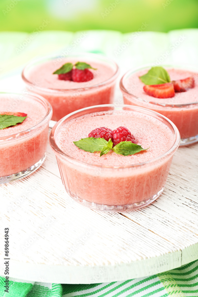 Delicious berry mousse in bowls on table close-up