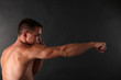 © Africa Studio - Handsome young muscular sportsman boxing on dark background