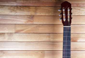 Guitar fretboard on wooden background