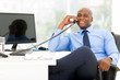 © michaeljung - african american businessman using landline phone