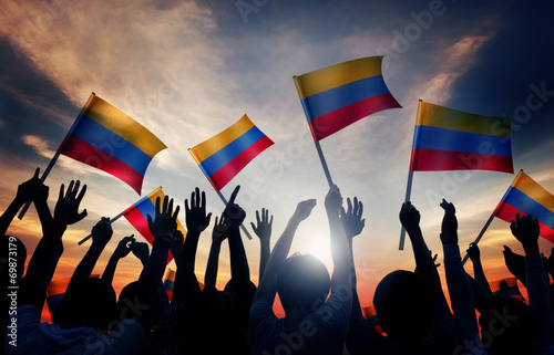 Fotografía Silhouettes of People Holding Flag of Colombia
