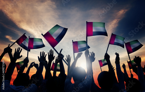 Fotografie, Obraz Group of People Waving Flag of UAE in Back Lit