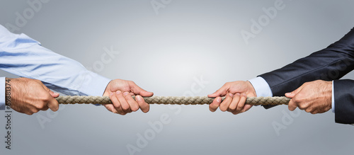 Fotografía Tug war, two businessman pulling a rope in opposite directions