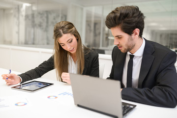 Business people working around table in modern office