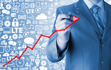 Business man drawing a growing graph