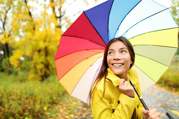 Wall Mural - Autumn / fall - woman happy with umbrella in rain