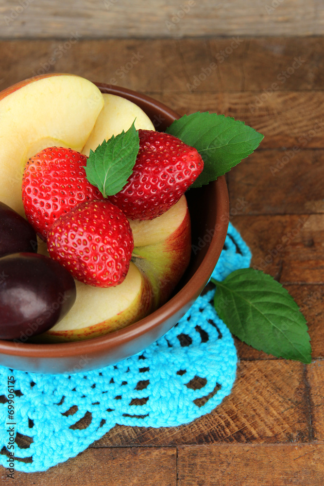 fresh tasty fruit salad on wooden table