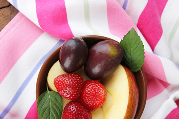 fresh tasty fruit salad on table