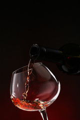 Poster - Red wine pouring into wine glass, close-up