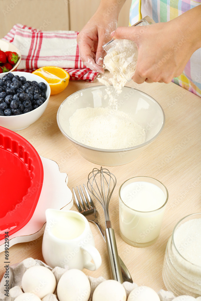 Baking tasty pie and ingredients for it on table in kitchen