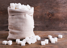 Refined Sugar In Bag On Wooden Background