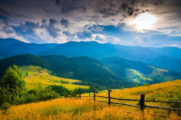 Wall Mural - amazing mountain landscape with fog and a haystack