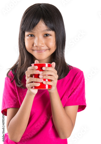 Young Asian Preteen Girl With A Red Mug Over White Background Stock