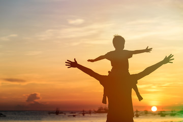 father and son on sunset beach