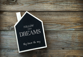Wall Mural - House Shaped Chalkboard sign  on rustic wood Follow your dreams