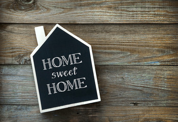 Wall Mural - House Shaped Chalkboard sign Home sweet Home on rustic wood