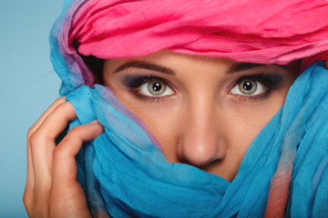 woman makeup on eyes hiden her face with shawl