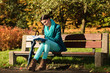 © Voyagerix - Girl relaxing in autumnal park reading book. Fall.