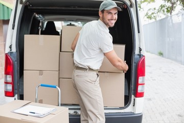 Delivery driver loading his van with boxes