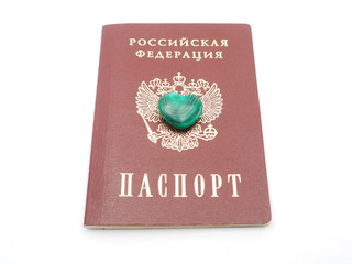 Wall Mural - malachite heart and Russian passport on white background