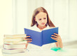© Syda Productions - girl studying and reading book at school