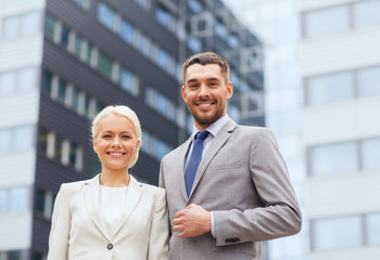 Poster - smiling businessmen standing over office building