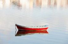 Lone Red Boat Floating