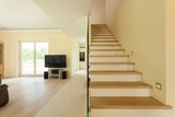 Fototapeta Morze - Spacious living room with staircase