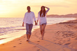 Fototapeta Sport - young couple  on beach have fun