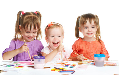 Wall Mural - happy little girl in kindergarten draw paints