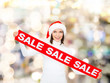 © Syda Productions - smiling woman in santa helper hat with sale sign