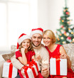 © Syda Productions - smiling family holding gift boxes and sparkles
